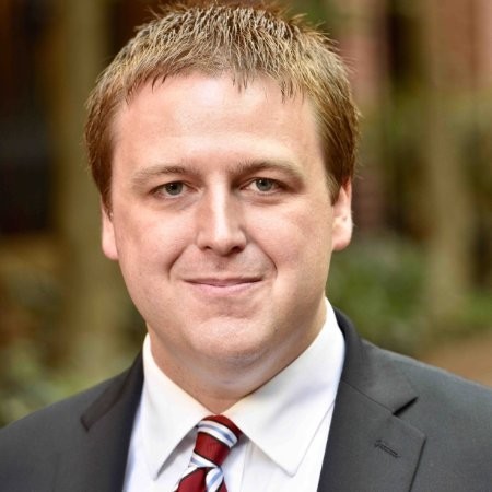 A person wearing a suit and tie
Description automatically generated